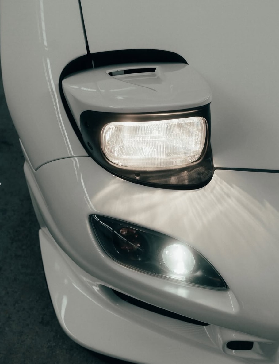 Close detail of the RX-7 pop-up headlight and front corner