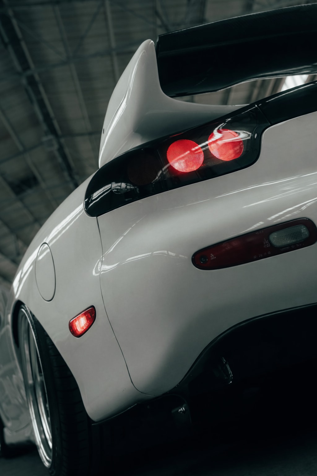 Low rear three-quarter detail of the RX-7 tail lights and wing