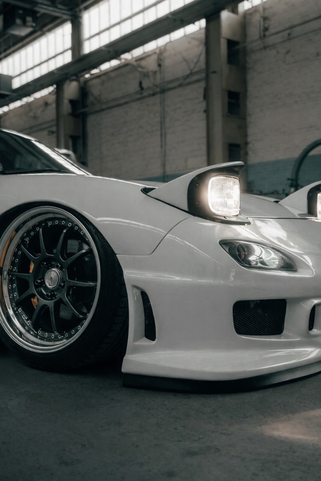 Front quarter detail of the RX-7 showing wheel fitment and ride height