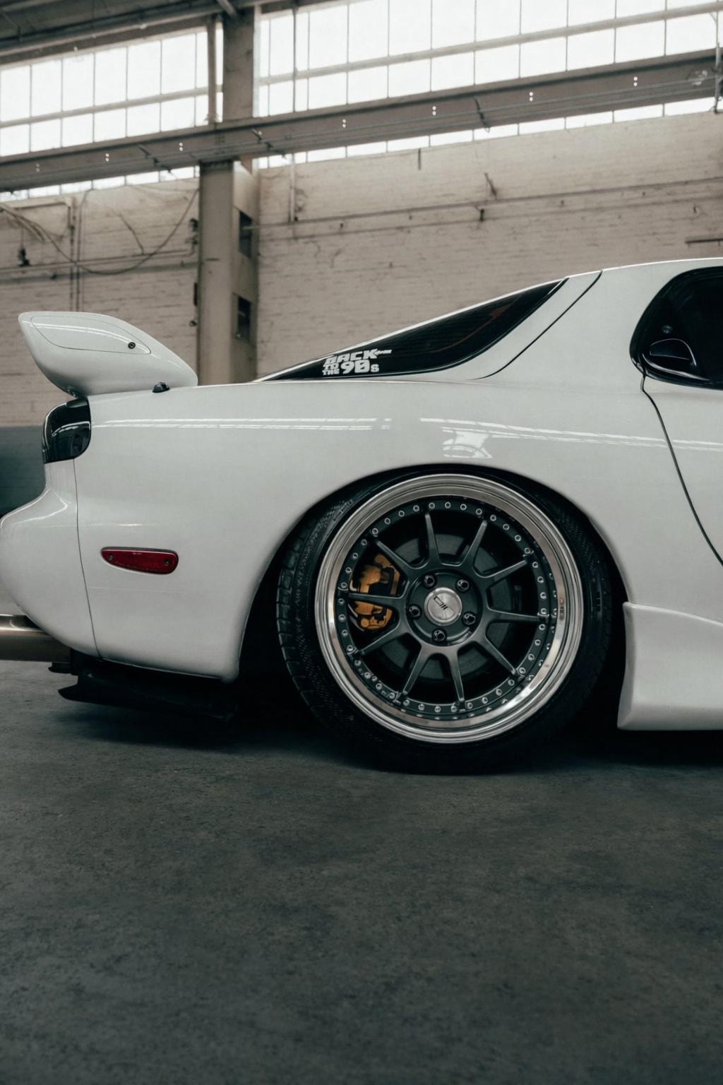 Rear quarter detail of the RX-7 showing the deep-lip wheel and side profile